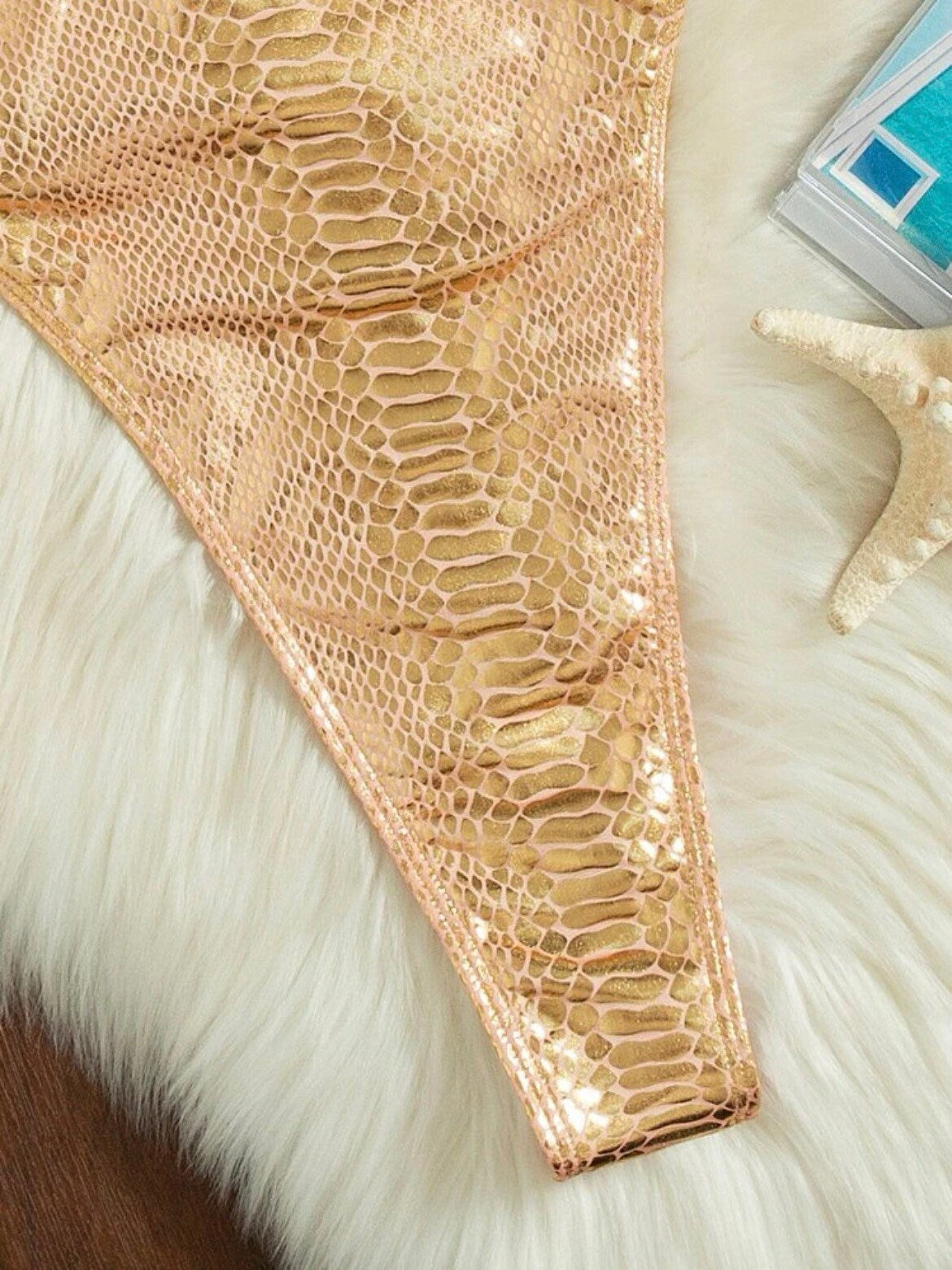 The Golden Alligator One Piece Swimsuit with a backless, high cut, sexy vibe in champagne gold