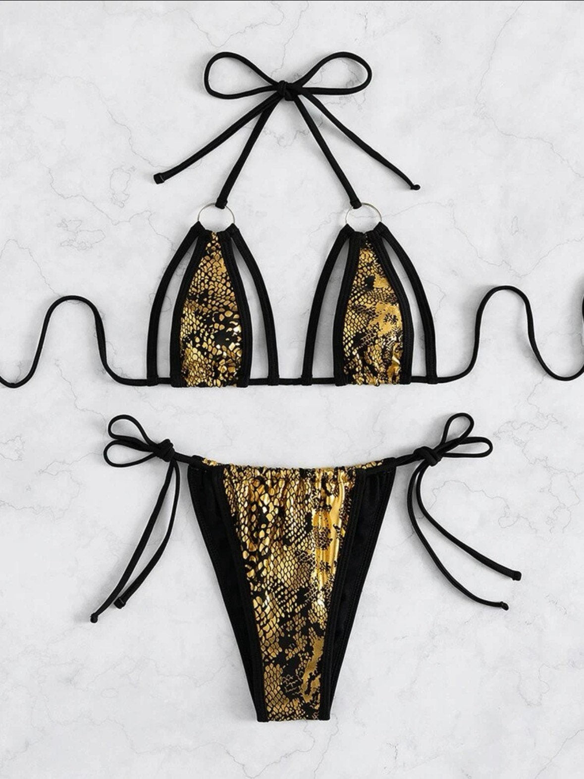 The Metallic gold snake print swim bikini with tie sides and snake black gold triangle cut out top tie and bottoms ring linked swimsuit set