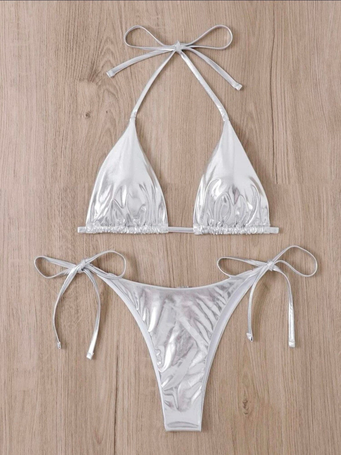 The Metallic silver swim bikini with tie sides and solid metallic silver print triangle halter top tie and bottoms swimsuit set