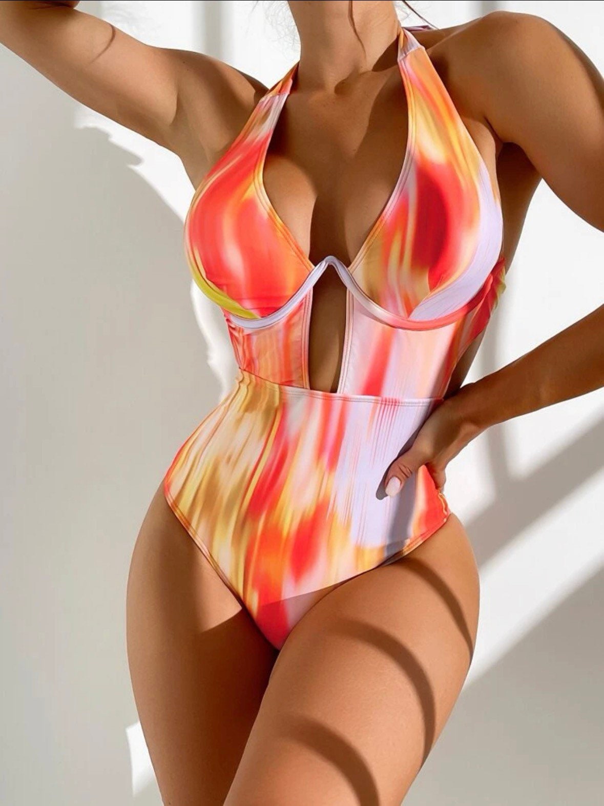 The Sexy Tie Dye One Piece Swimsuit with an underwire cutout halter tie dye pattern cut out, sexy vibe in orange or pink