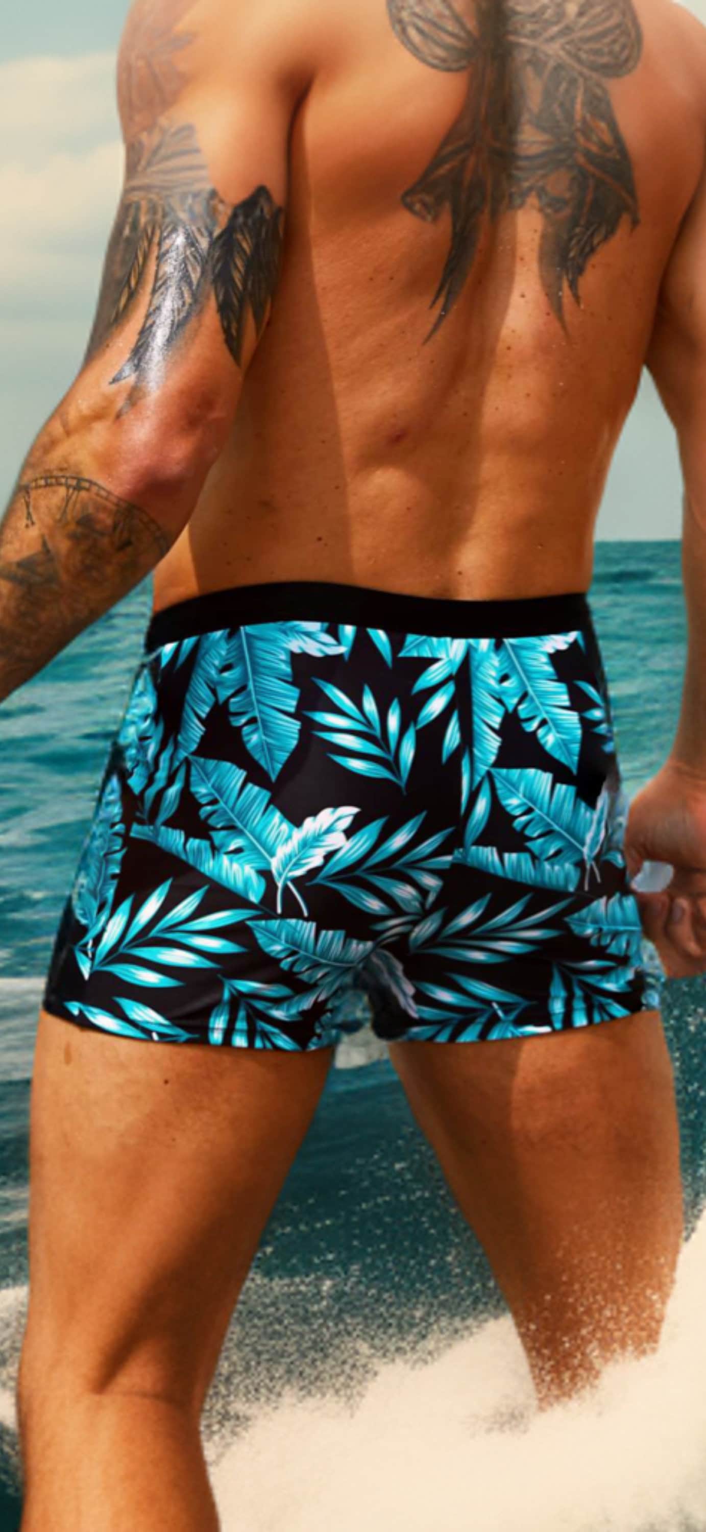 The Bryon Men’s Swimwear Blue and Black Tropical Print Drawstring Waist Swim Trunks